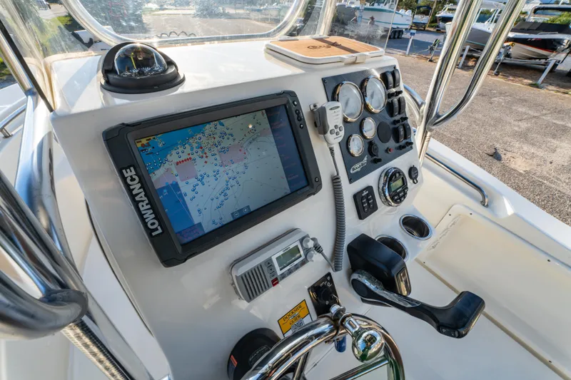 Slide: The Image of 2019 Bulls Bay 200 CC boat dashboard with navigation system and controls. - 18