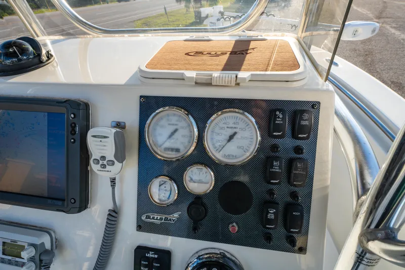 Slide: The Image of 2019 Bulls Bay 200 CC boat dashboard with gauges and controls. - 19