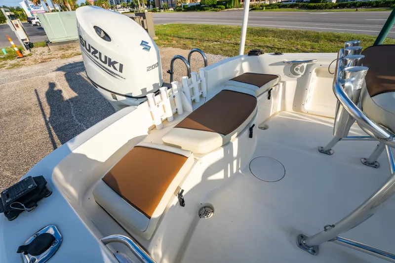 Slide: The Image of 2019 Bulls Bay 200 CC boat interior with Suzuki 200 engine, featuring cushioned seating. - 21
