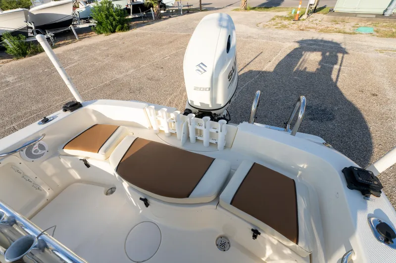 Slide: The Image of 2019 Bulls Bay 200 CC boat interior with Suzuki 200 engine, featuring cushioned seating. - 23
