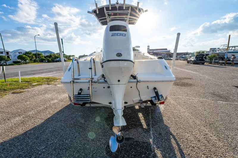 Slide: The Image of 2019 Bulls Bay 200 CC boat with outboard motor in a sunny parking lot. - 6