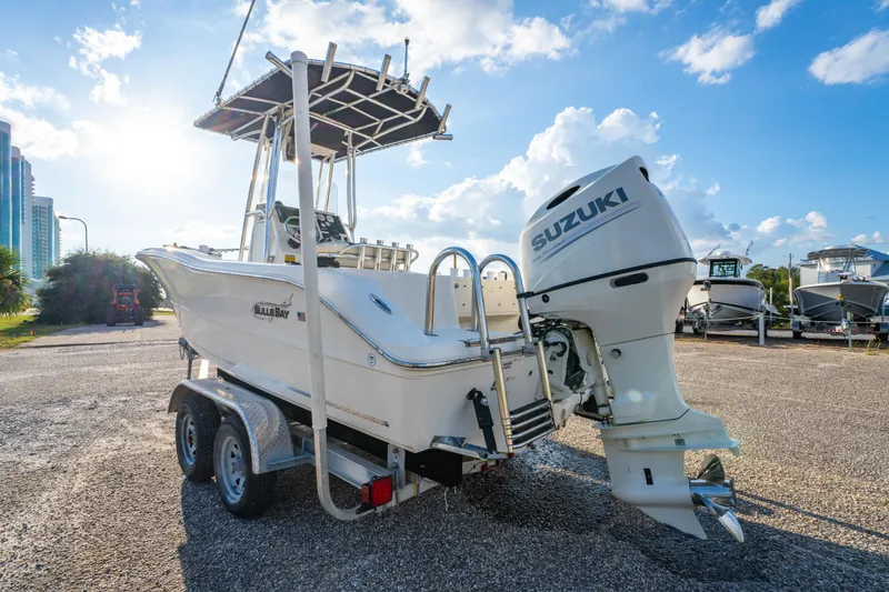 Slide: The Image of 2019 Bulls Bay 200 CC boat with Suzuki outboard motor on a trailer, sunny day. - 8