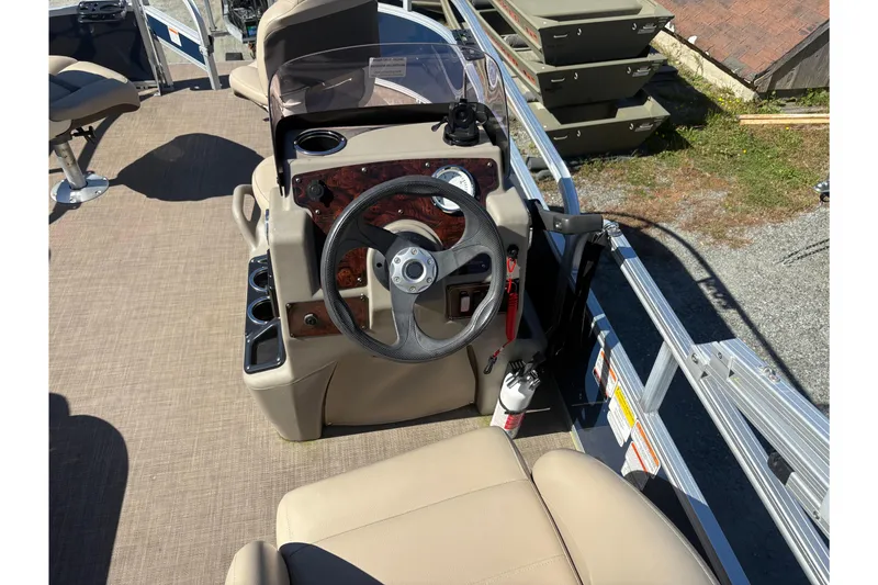 Slide: The Image of 2022 Sun Tracker Bass Buggy 16 XL boat interior with steering wheel and seating. - 4