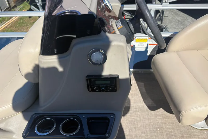 Slide: The Image of Interior of 2022 Sun Tracker Bass Buggy 16 XL with steering console and cup holders. - 6