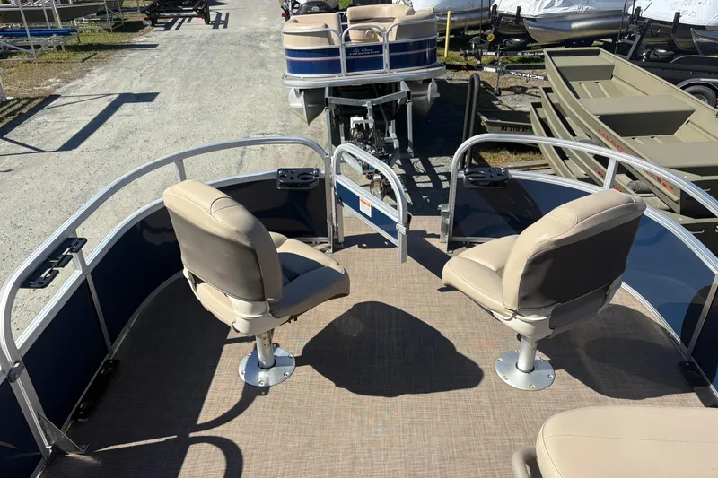 Slide: The Image of 2022 Sun Tracker Bass Buggy 16 XL pontoon boat with beige seats and blue accents. - 7