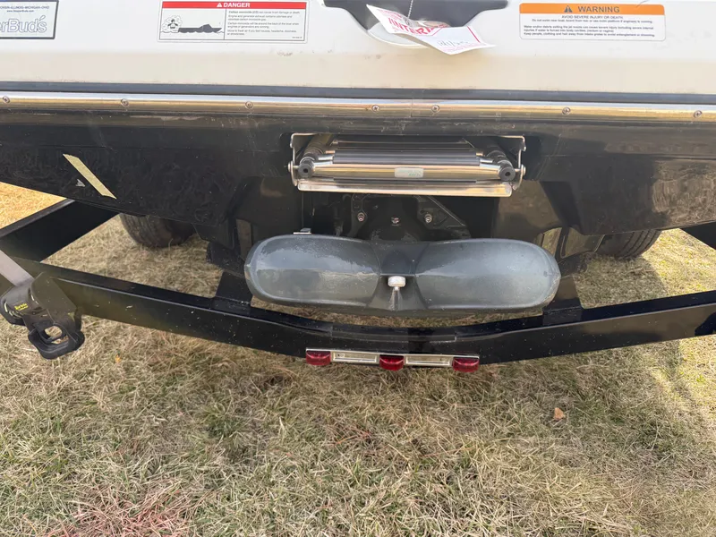 Slide: The Image of Rear view of a 2021 Scarab 195 ID boat on a trailer. - 2