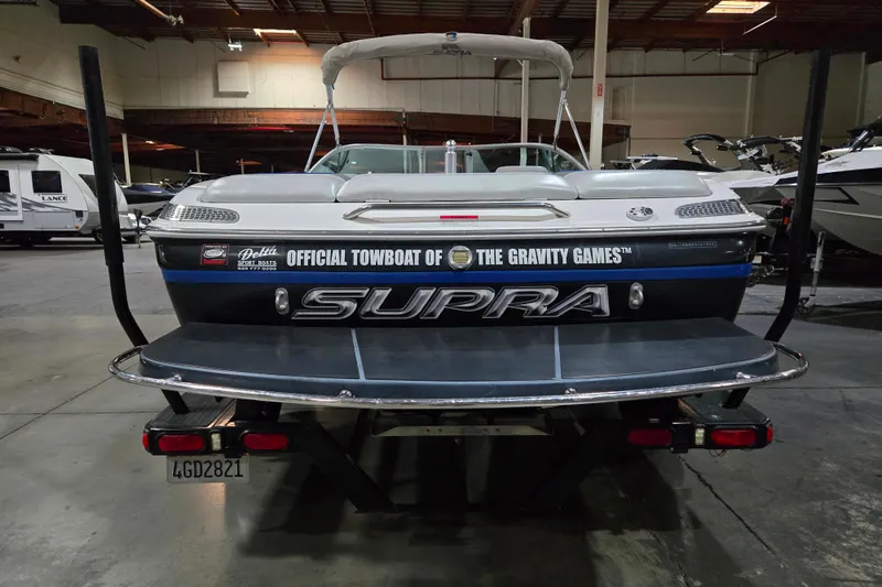 Slide: The Image of 2005 Supra Sunsport 22 V boat, official towboat of The Gravity Games, in a showroom. - 4