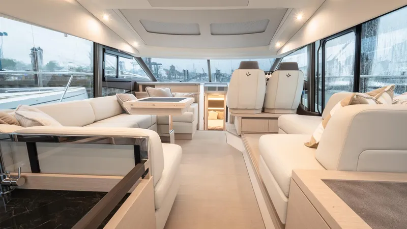 Slide: The Image of Luxurious interior of 2023 Prestige 520S yacht with elegant seating and panoramic windows. - 11