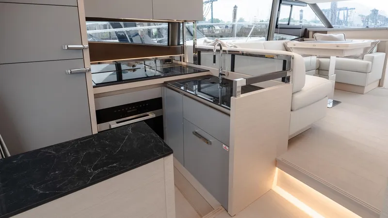 Slide: The Image of Modern kitchen interior on 2023 Prestige 520S yacht, featuring sleek cabinetry and elegant countertops. - 16