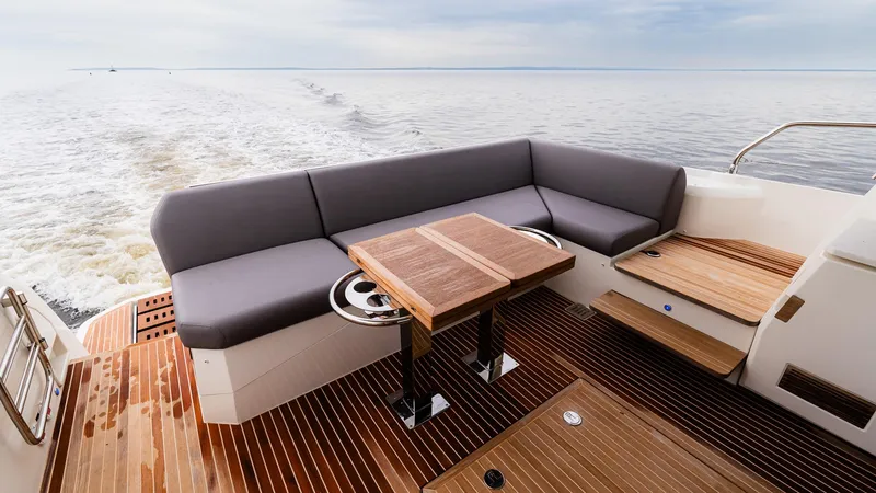 Slide: The Image of Luxurious 2023 Prestige 520S yacht deck with elegant seating and wooden flooring. - 6