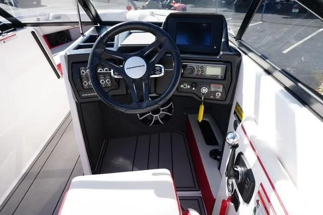 Slide: The Image of 2019 Moomba Craz boat cockpit with steering wheel and control panel. - 12