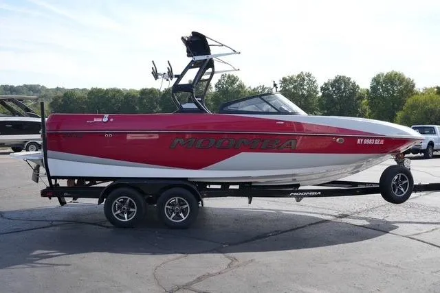 Slide: The Image of 2019 Moomba Craz boat on trailer, red and white design, parked outdoors. - 3