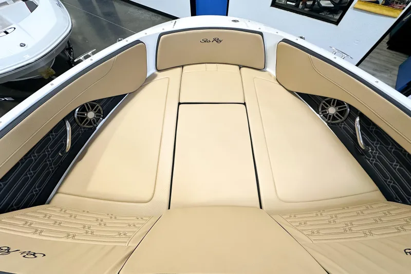 Slide: The Image of 2026 Sea Ray SPX 210 boat interior with beige seating and sleek design. - 10