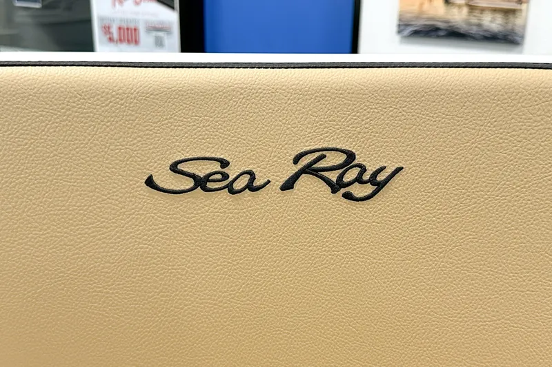 Slide: The Image of Sea Ray logo on beige leather, 2026 SPX 210 boat interior. - 12