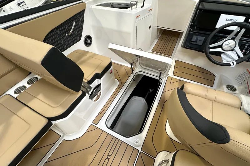 Slide: The Image of 2026 Sea Ray SPX 210 boat interior with tan seating and storage compartment open. - 15