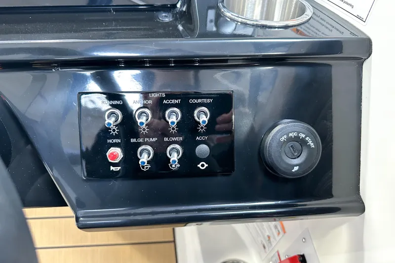 Slide: The Image of Control panel of 2026 Sea Ray SPX 210 boat with switches and ignition. - 18