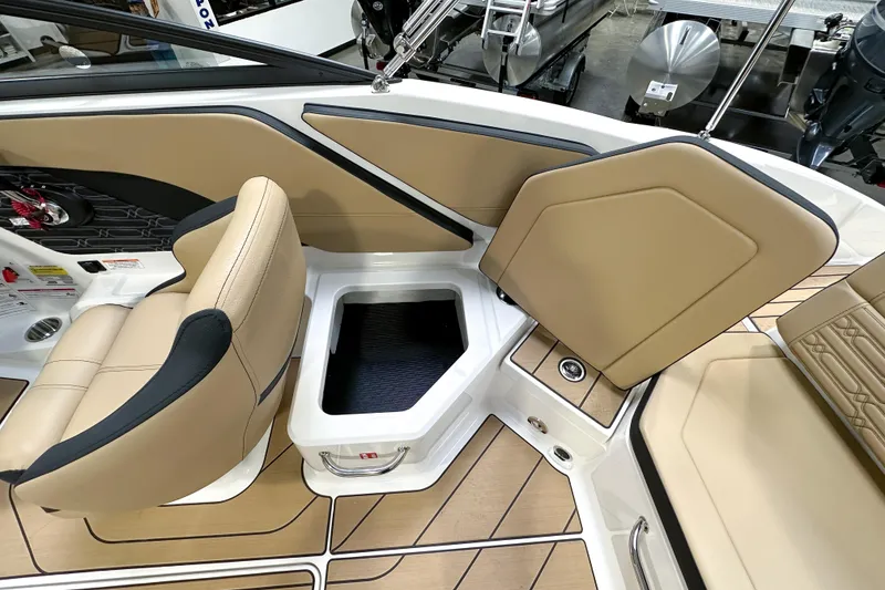 Slide: The Image of 2026 Sea Ray SPX 210 boat interior with tan seating and storage compartment. - 19