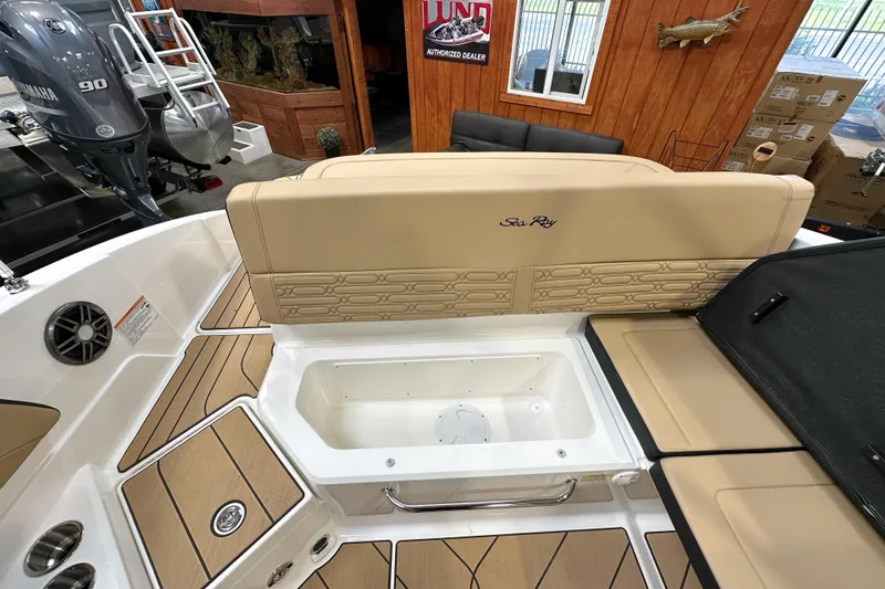 Slide: The Image of 2026 Sea Ray SPX 210 boat interior with tan seating and storage compartment. - 20