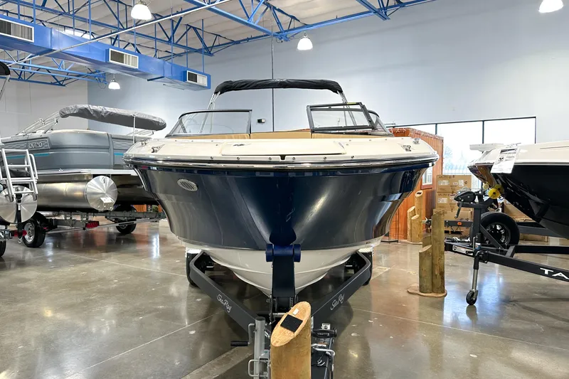 Slide: The Image of 2026 Sea Ray SPX 210 boat displayed in a showroom with polished floors. - 23