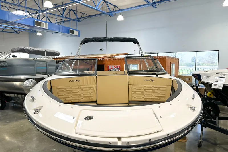 Slide: The Image of 2026 Sea Ray SPX 210 boat displayed indoors, featuring beige seating and sleek design. - 24