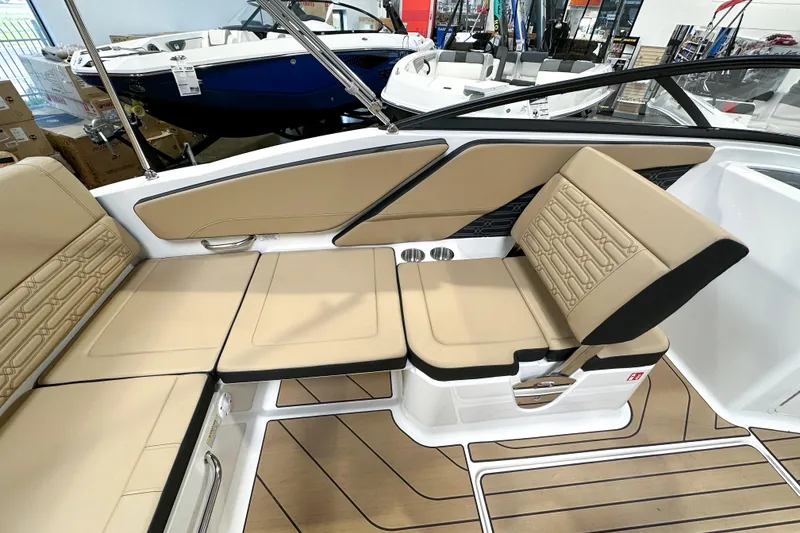 Slide: The Image of 2026 Sea Ray SPX 210 boat interior with beige seating and modern design. - 7