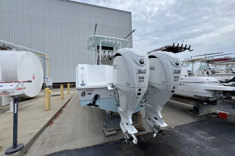 Slide: The Image of 2024 Sea Hunt Gamefish 28 with twin Yamaha 300 V6 engines, docked outdoors. - 12