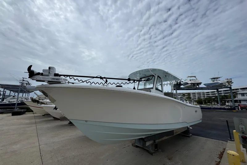 Slide: The Image of 2024 Sea Hunt Gamefish 28 boat on display under cloudy sky. - 2