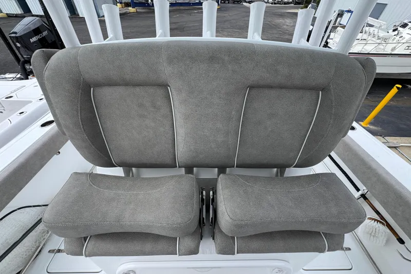 Slide: The Image of 2024 Sea Hunt Gamefish 28 boat seating with gray upholstery and rod holders. - 26