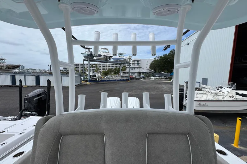 Slide: The Image of 2024 Sea Hunt Gamefish 28 boat interior with rod holders, docked at a marina. - 27