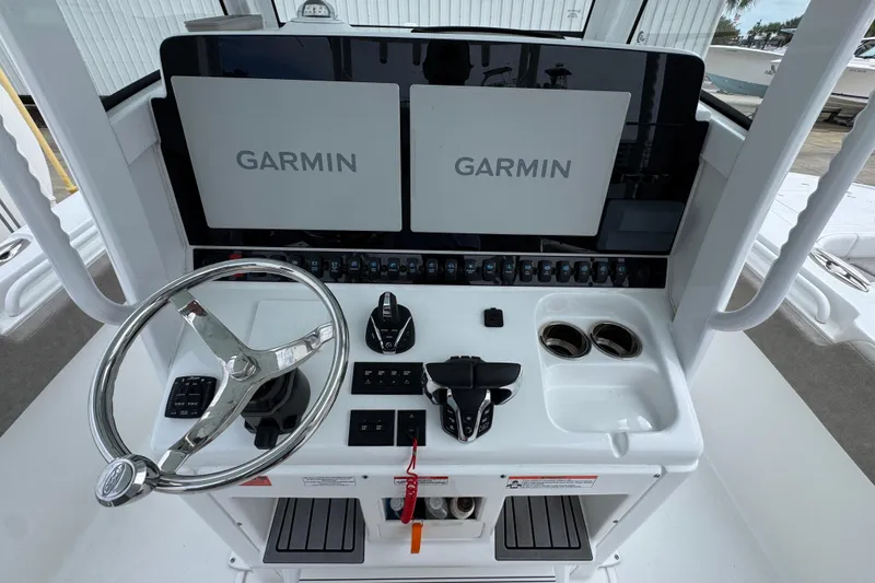 Slide: The Image of 2024 Sea Hunt Gamefish 28 helm with dual Garmin displays and steering wheel. - 29