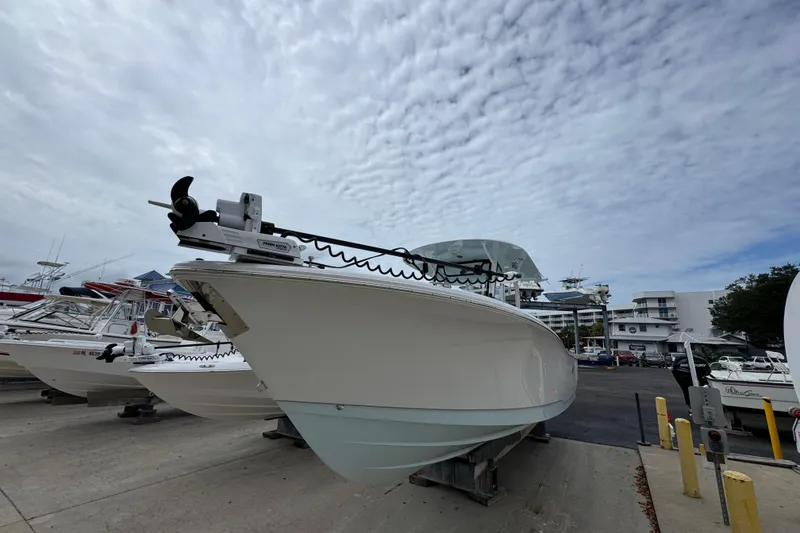Slide: The Image of 2024 Sea Hunt Gamefish 28 boat on display at a marina under a cloudy sky. - 3