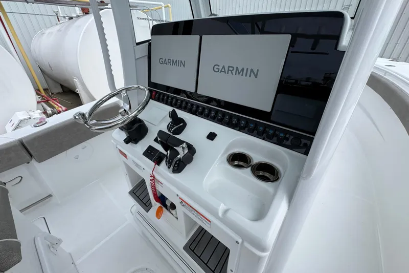 Slide: The Image of 2024 Sea Hunt Gamefish 28 helm with dual Garmin displays and steering wheel. - 31