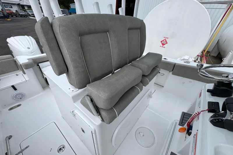 Slide: The Image of 2024 Sea Hunt Gamefish 28 boat interior with cushioned seating and steering console. - 32