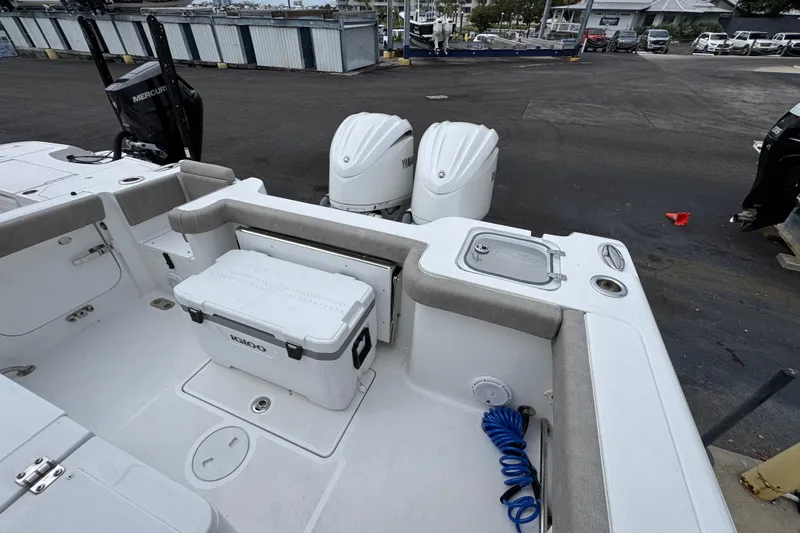 Slide: The Image of 2024 Sea Hunt Gamefish 28 boat interior with dual engines and Igloo cooler. - 36