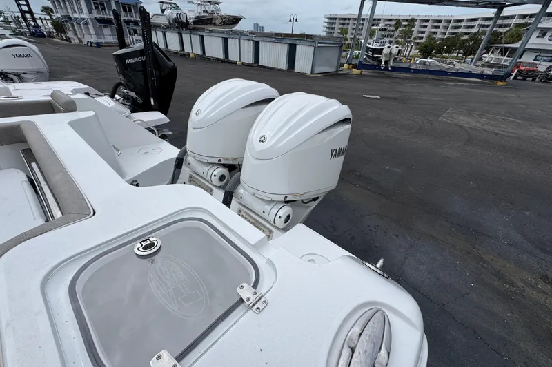 Slide: The Image of 2024 Sea Hunt Gamefish 28 with dual Yamaha outboard motors at a marina. - 38