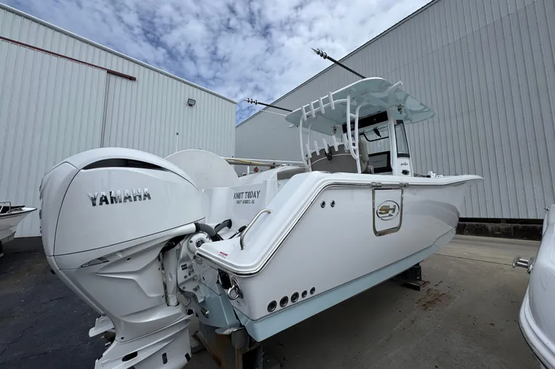 Slide: The Image of 2024 Sea Hunt Gamefish 28 boat with Yamaha engines, docked outdoors. - 9