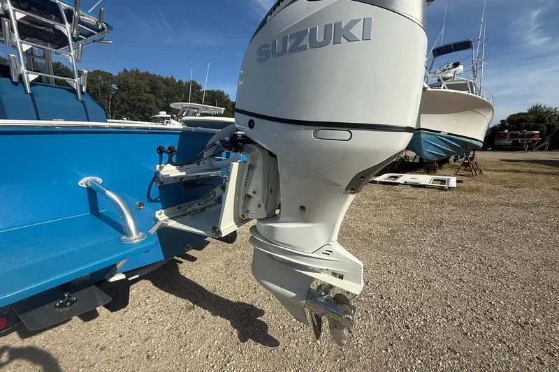 Slide: The Image of Valentino 28CC 2020 boat with Suzuki outboard motor in a marina setting. - 11