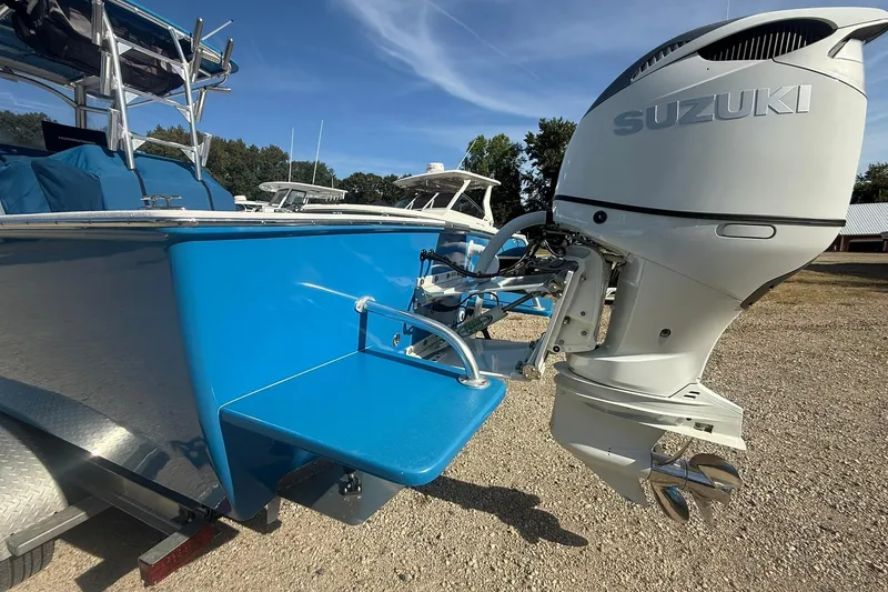 Slide: The Image of Valentino 28CC boat with Suzuki outboard motor, 2020 model, featuring blue hull and swim platform. - 12