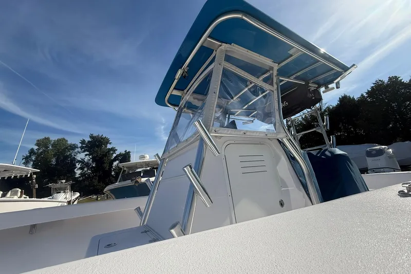 Slide: The Image of 2020 Valentino 28CC boat with blue canopy under clear sky. - 14