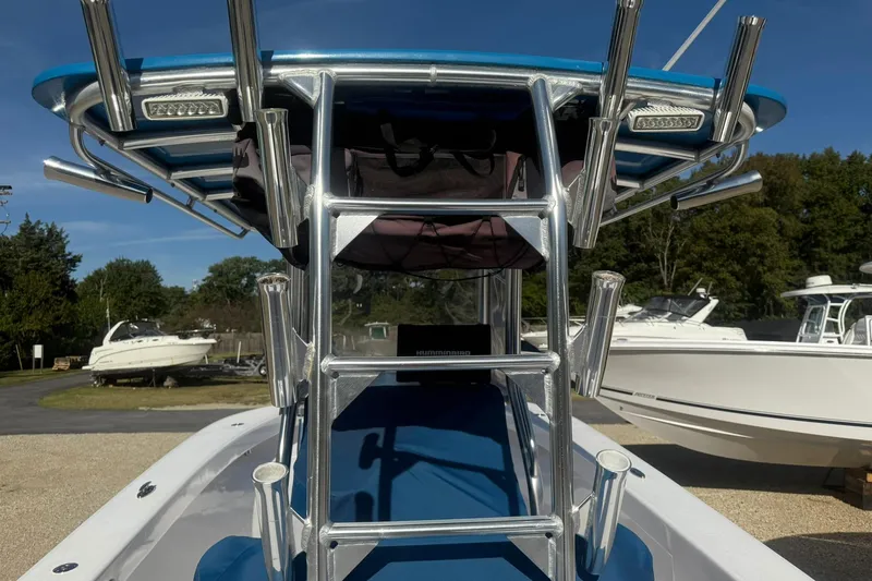 Slide: The Image of Valentino 28CC boat, 2020 model, featuring a sturdy T-top and rod holders, docked outdoors. - 20