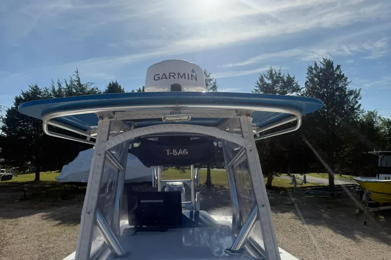 Slide: The Image of 2020 Valentino 28CC boat with Garmin equipment, parked outdoors under a clear sky. - 27