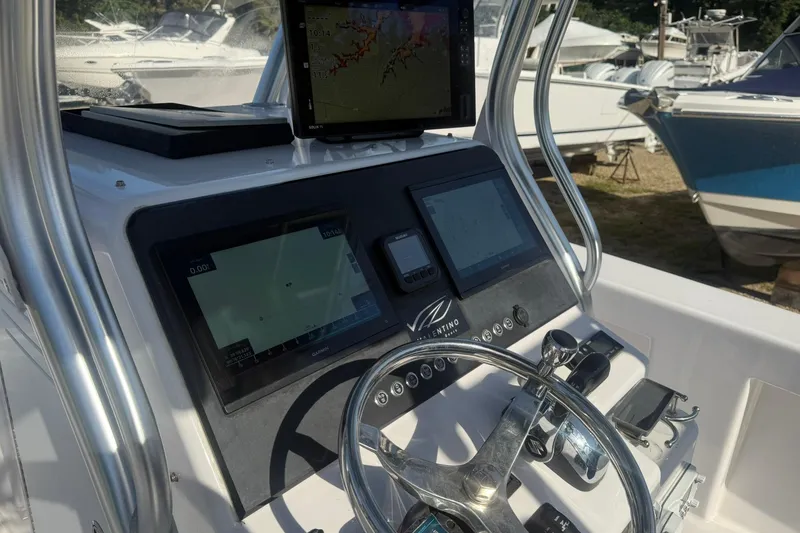 Slide: The Image of Valentino 28CC 2020 boat dashboard with navigation screens and steering wheel. - 29