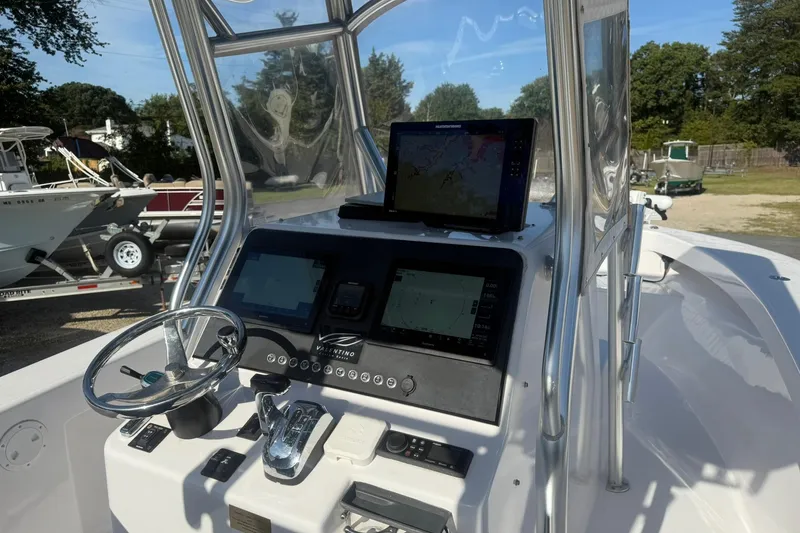 Slide: The Image of 2020 Valentino 28CC boat dashboard with navigation screens and steering wheel. - 30