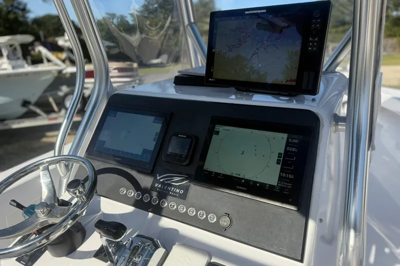 Slide: The Image of Valentino 28CC 2020 boat dashboard with navigation screens and steering wheel. - 35