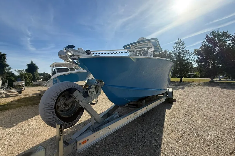 Slide: The Image of Blue 2020 Valentino 28CC boat on trailer under sunny sky. - 4