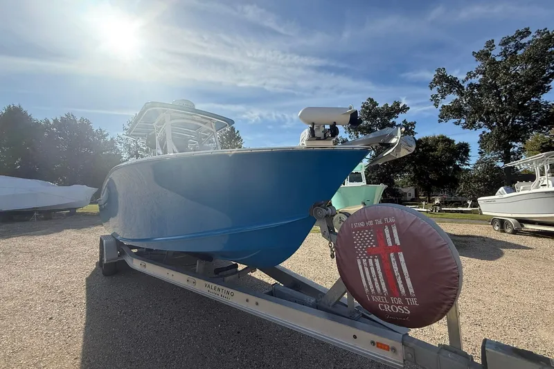 Slide: The Image of 2020 Valentino 28CC boat on trailer under sunny sky, parked outdoors. - 5