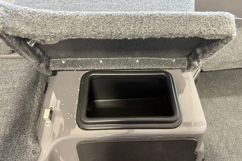 Slide: The Image of 2025 Skeeter ZXR20 storage compartment with open lid, featuring carpeted interior. - 11