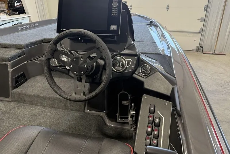 Slide: The Image of 2025 Skeeter ZXR20 boat interior with steering wheel and control panel. - 14