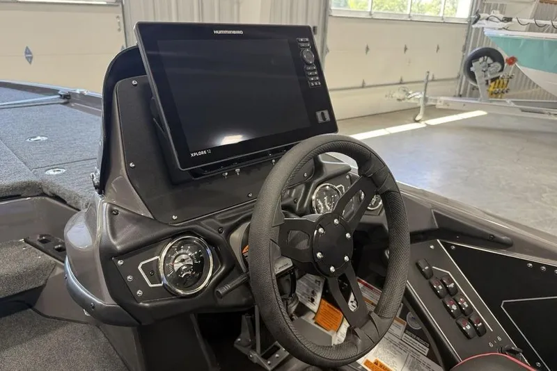 Slide: The Image of 2025 Skeeter ZXR20 boat dashboard with steering wheel and advanced navigation display. - 15