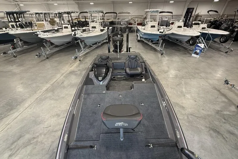 Slide: The Image of 2025 Skeeter ZXR20 boat in showroom, surrounded by various other boats. - 17